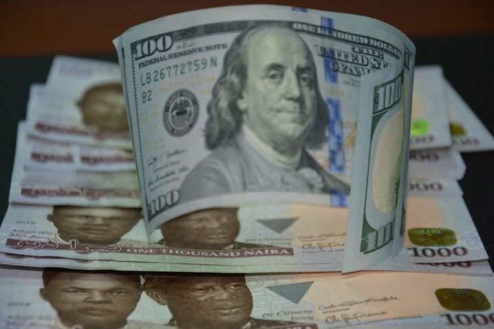 A 100 dollar bill and 1000 naira notes