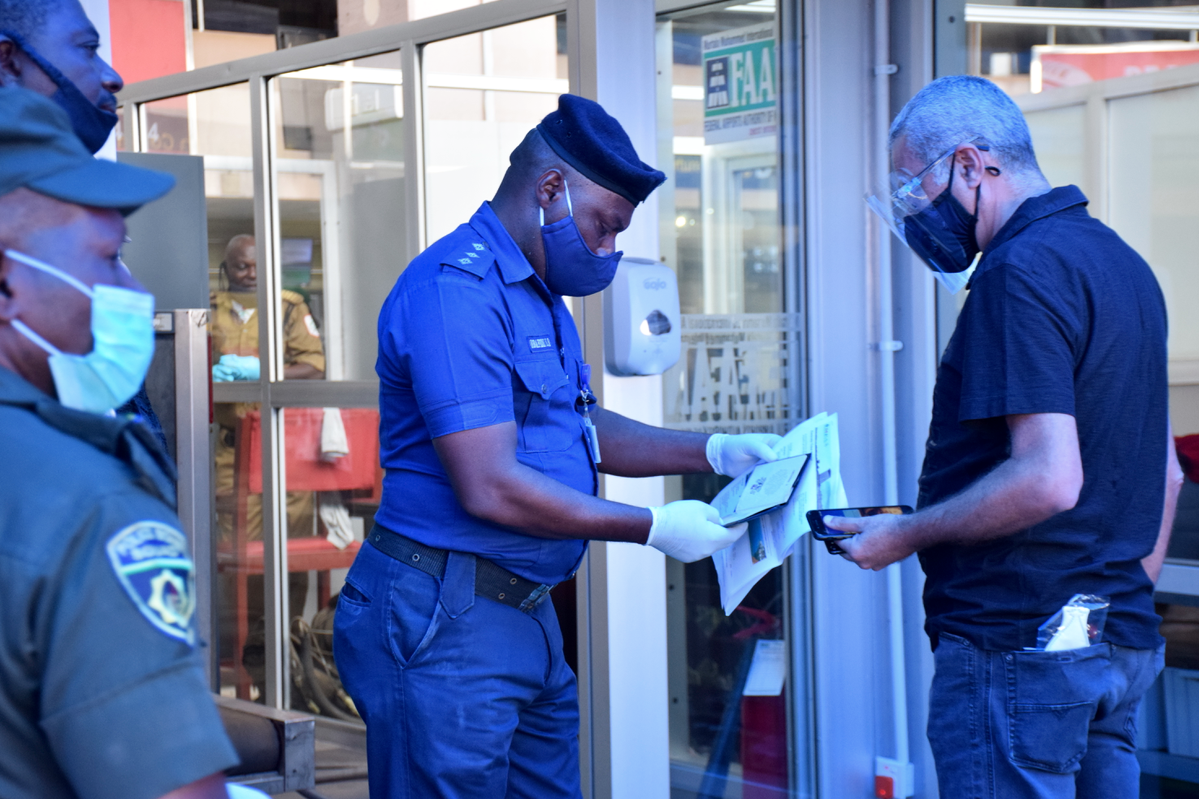 Airport official checking a passengers document 