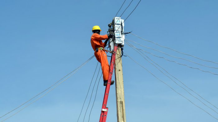an electricity worker on a pole