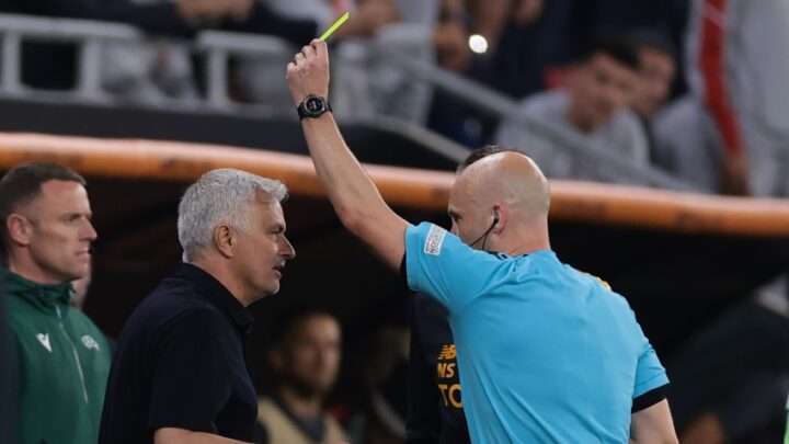 Anthony Taylor brandishes a yellow card to Jose Mourinho during Roma's Europa league final loss to Sevilla