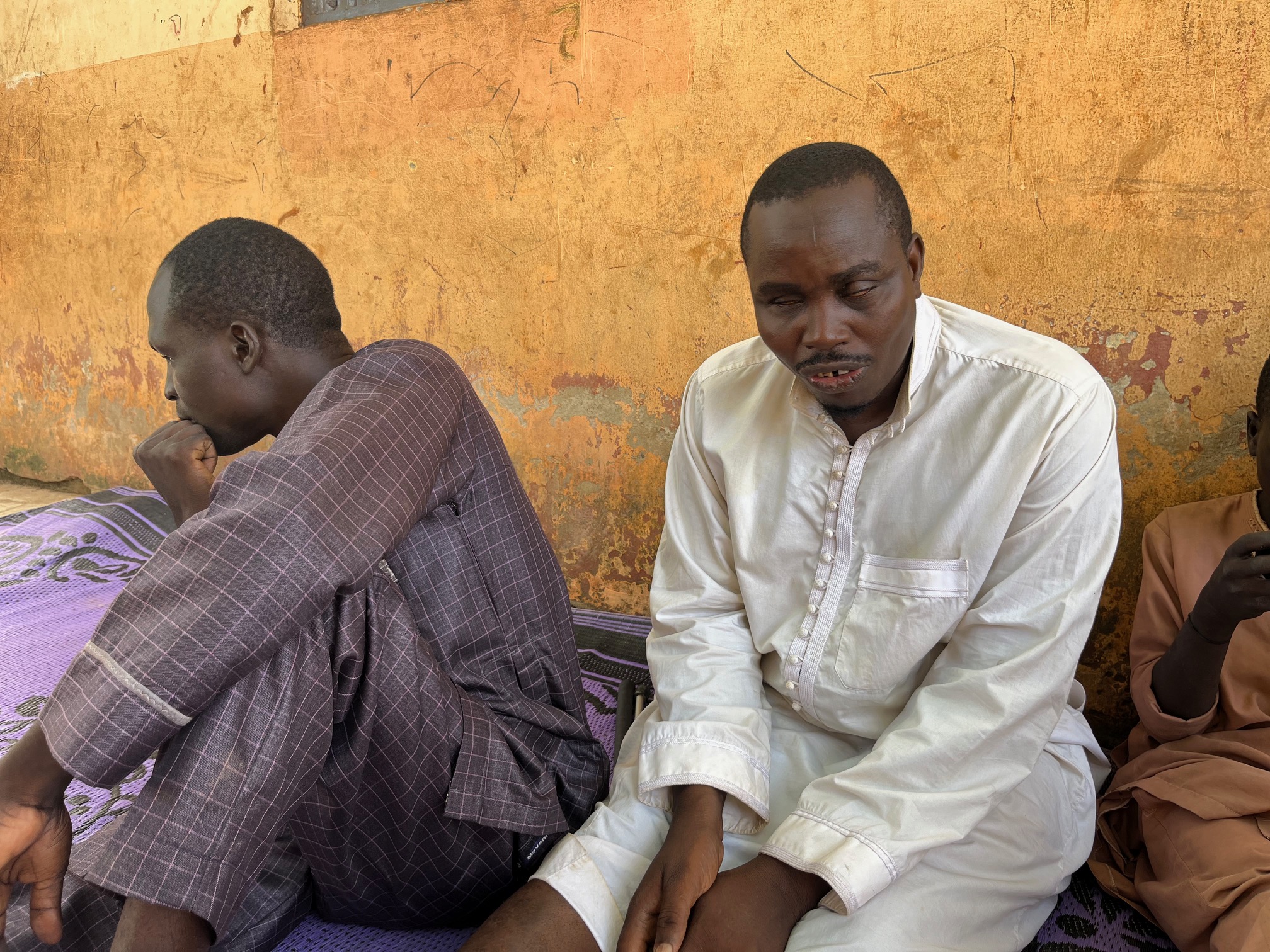 Aliyu (R) sitting with Habib, his friend (L). Photo credit: Claire Mom/TheCable