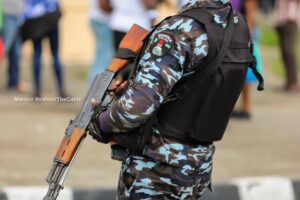 Police officer carrying a rifle