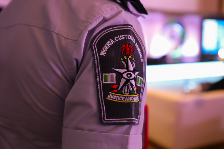 A close up of the Nigeria customs badge on an officer's arm