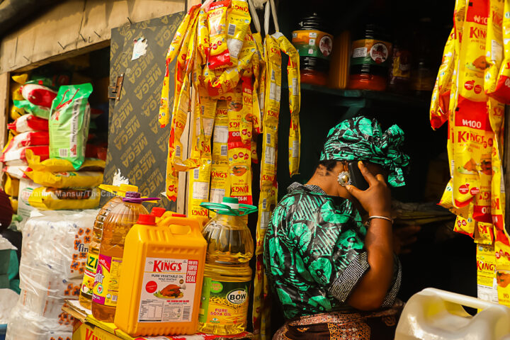 A store owner and her wares displayed at a market