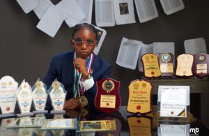 Tolulope Ekundayo, a 19-year-old graduate of Adeleke University, displays her awards