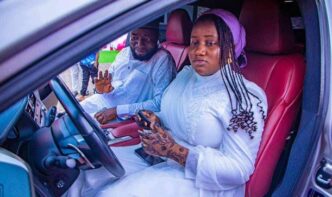 Yusuf Adamu Gagdi, a federal lawmaker representing Plateau state, and his daughter inside a SUV car