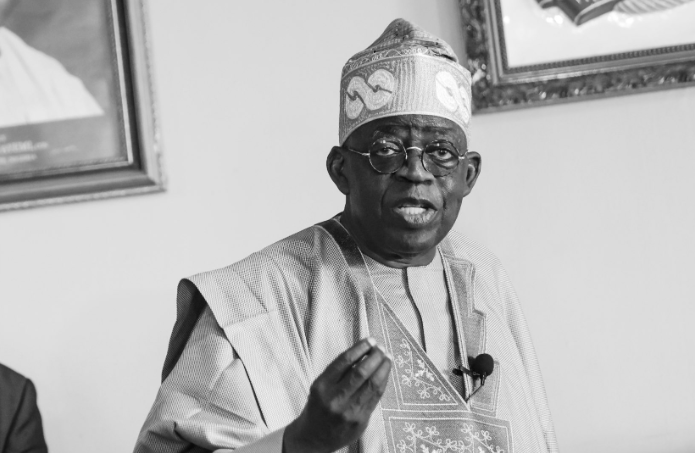 President Bola Tinubu adorning a cap with the broken shackle symbol