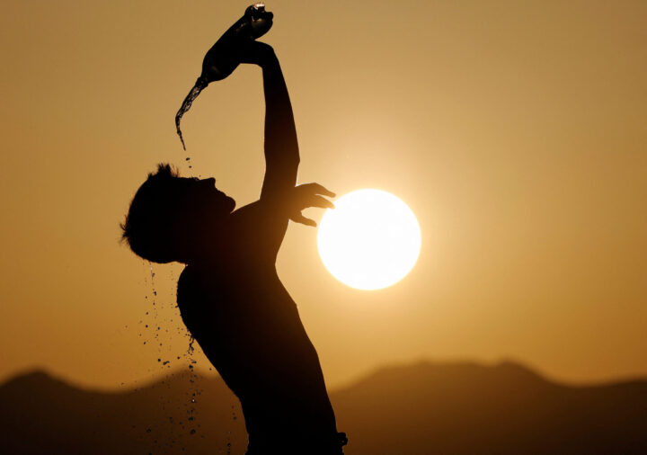 Heatwave file photo of a runner cooling down with water in Skopje, North Macedonia on July 12, 2023. Photo credit: REUTERS/Ognen Teofilovski/