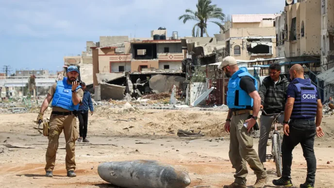 A UN team inspects an unexploded 1,000-pound bomb lying on a main road in Khan Younis. Photo credit: OCHA