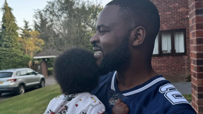 Rapper Falz holding a baby