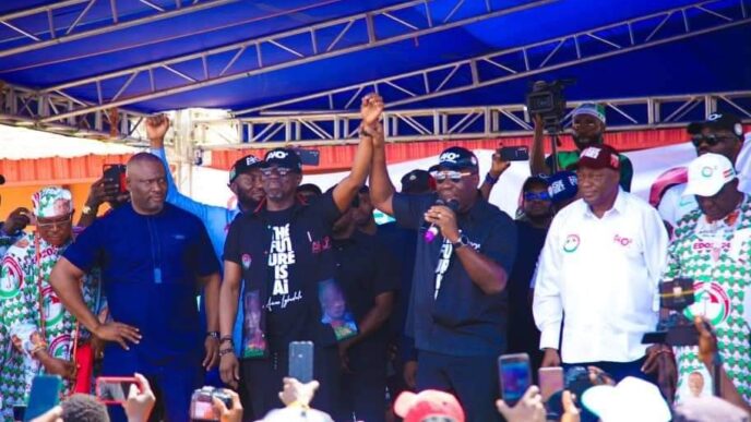 Godwin Obaseki, governor of Edo, presenting Asue Ighodalo, candidate of the PDP, to residents during a campaign rally