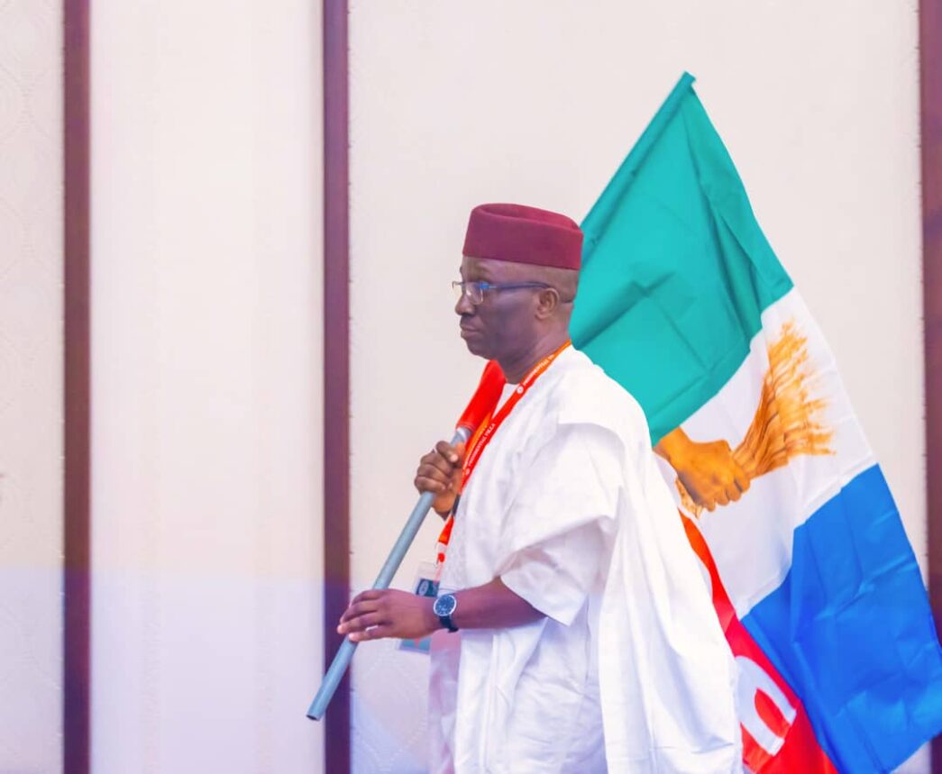 Monday Okpebholo with the APC flag