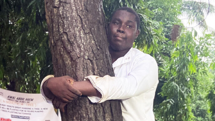 Abdul Hakim Awal, the 23-year-old journalist from Kumasi, Ghana, has broken the world record for the longest time to hug a tree