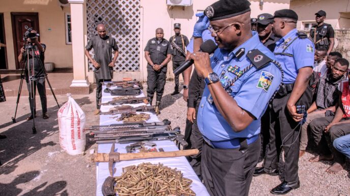 Police displaying weapons after 'arresting arms dealer' in Plateau