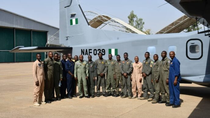 NAF engineers with the revived aircraft in the background