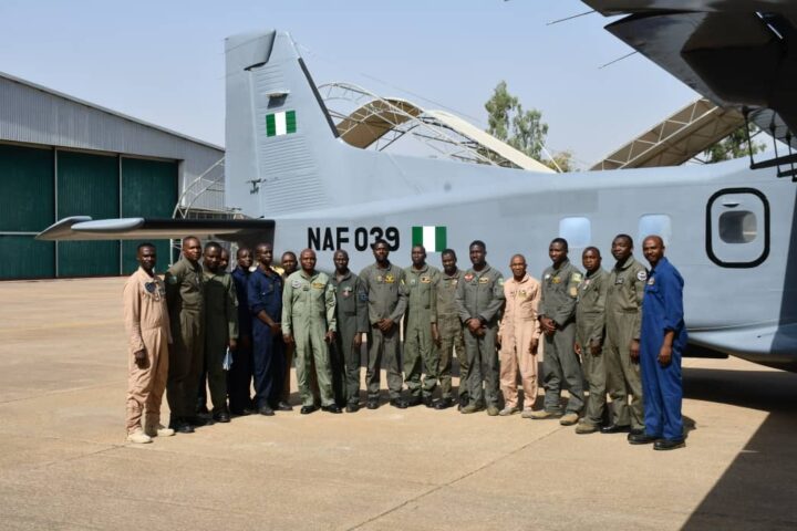 NAF engineers with the revived aircraft in the background