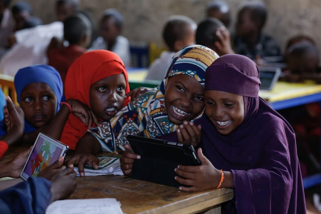 Children learning with a tablet computer. (Photo credit: Save The Children International)