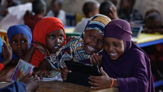 Children learning with a tablet computer. (Photo credit: Save The Children International)