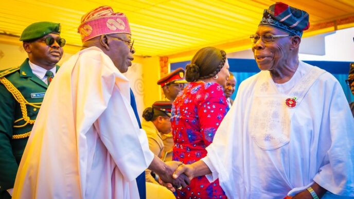 President Bola Tinubu shaking hands with former President Olusegun Obasanjo in Accra