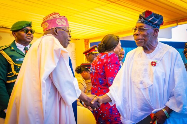 President Bola Tinubu shaking hands with former President Olusegun Obasanjo in Accra