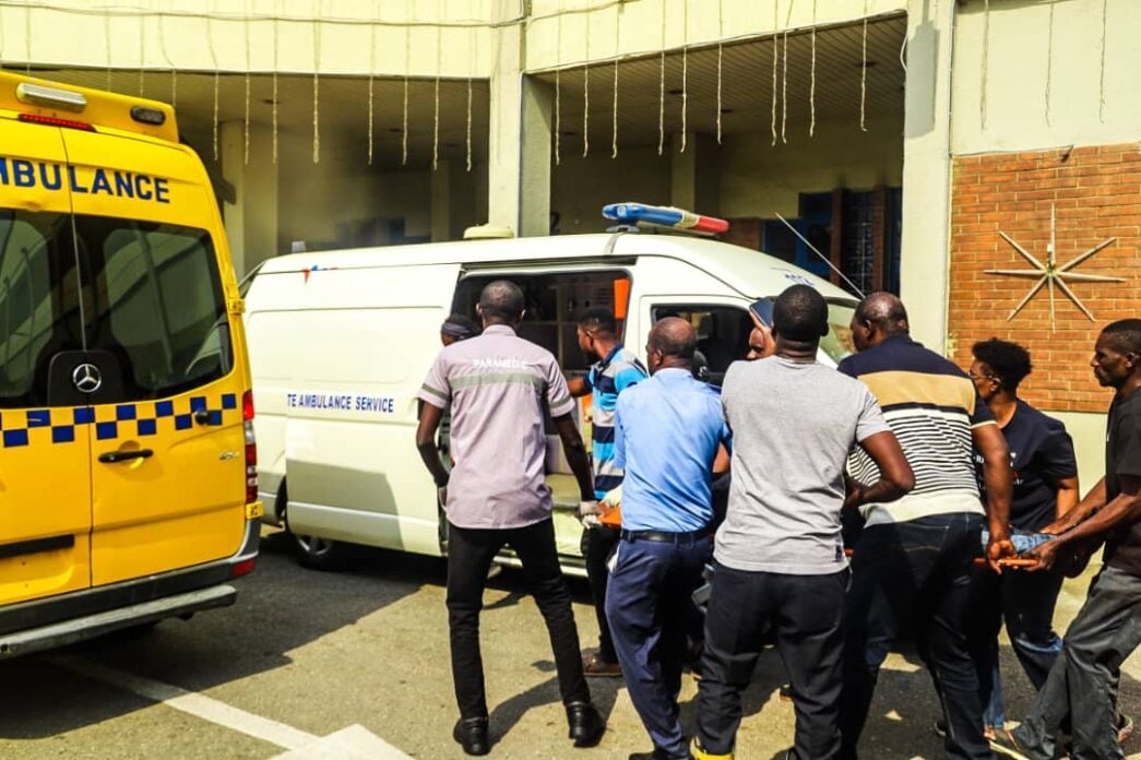 A factory worker being taken to an ambulance shortly before passing away