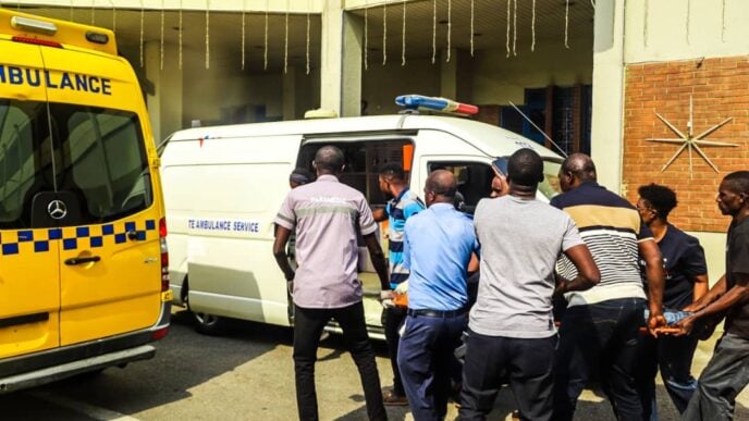 A factory worker being taken to an ambulance shortly before passing away