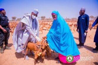 Dikko Radda, governor of Katsina state, presents goats to women in the state