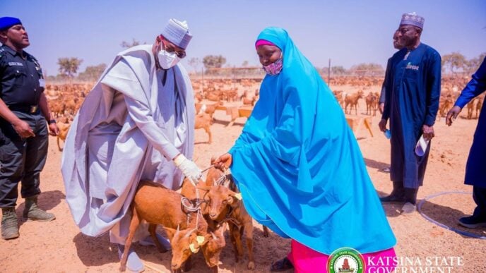 Dikko Radda, governor of Katsina state, presents goats to women in the state