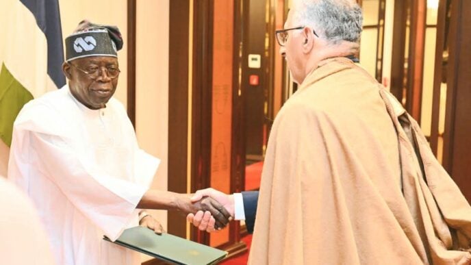 Tinubu (left) is received by an Ethiopian government official on arrival in Addis Ababa